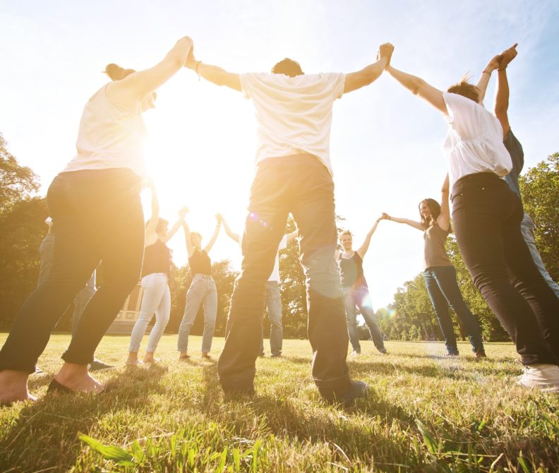 large group of friends enjoying a summer day at the park, back to school